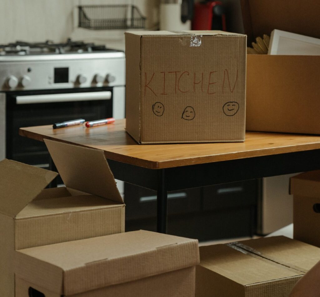 Box labeled kitchen on a kitchen counter