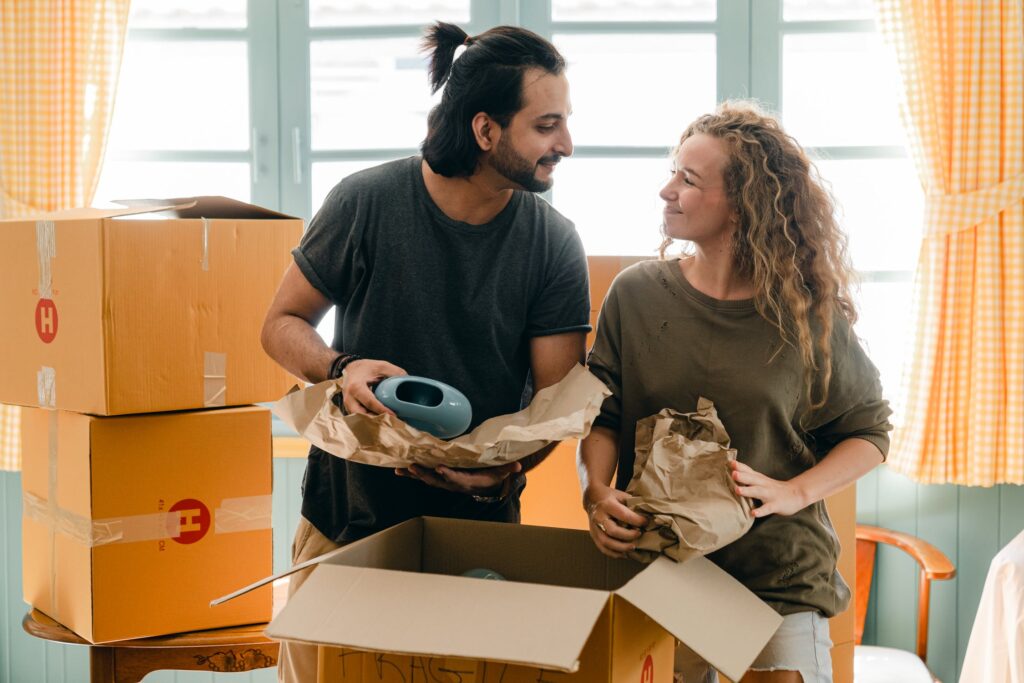 Couple packing delicate items for moving