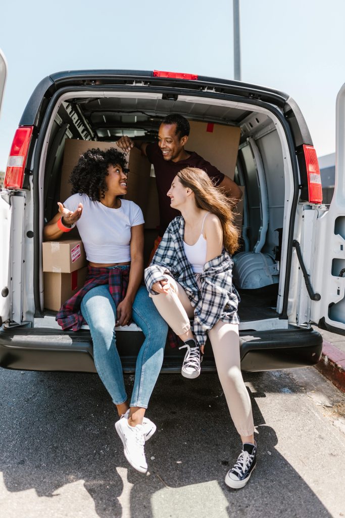 Students with boxes packed in a van